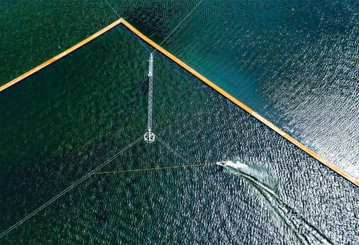 Aerial wakeboarding. Top view of awakeboard rider in wake cable park. Water sport background. Drone top down shot