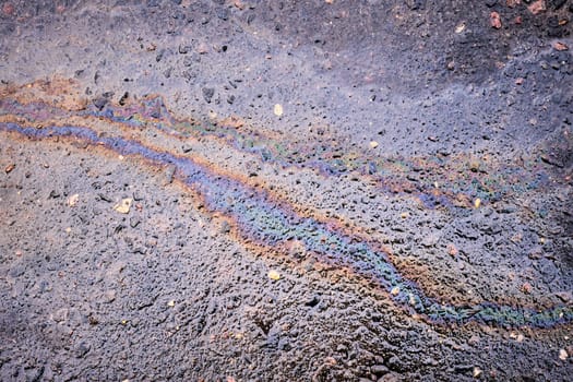 Petrol Oil Pollution Rainbow Gasoline Leak on Pavement.