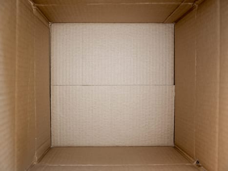 Opened cardboard box close up. Empty open rectangular cardboard box close up background and texture