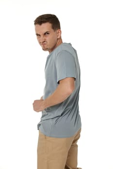 annoyed angry man standing on white studio background