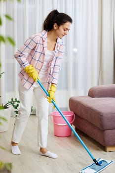 young woman cleaning and washing floor at living room, daily housekeeping