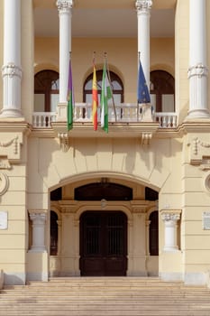 Malaga, Spain- 26-01-2024: Ornate entrance of the City Hall of Malaga with European flags, a perfect representation for governmental or historical content. Ayuntamiento de Malaga