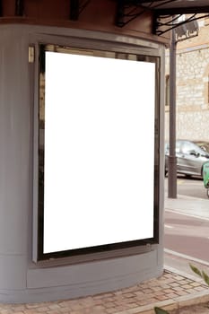 Empty outdoor advertisement space on a kiosk, nestled on a city street, ideal for marketing and urban design. Copy space for your picture, text. Vertical billboard mock up