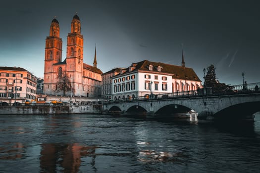 View of the River Limmat and the old town of Zurich with Grossmunster shortly after sunset. High quality photo