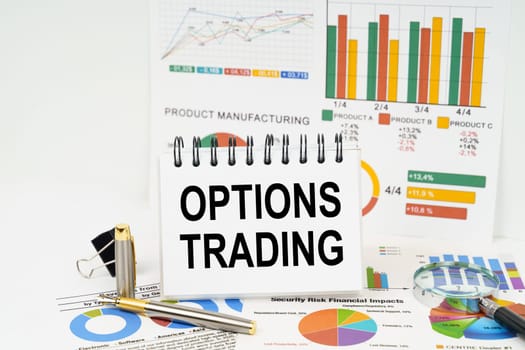 Business concept. On the table are reports with graphs and a notepad with the inscription - Options trading