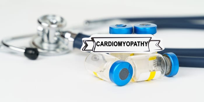 Medical concept. On the table there is a stethoscope, injections and a sign with the inscription - cardiomyopathy