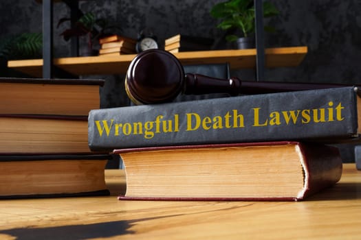 Pile of books, gavel and Wrongful death lawsuit.