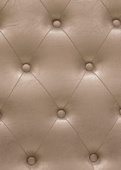 A padded leather cloth in a delicate shade of beige captivating with its meticulously crafted intricate texture carefully designed with quilting pattern which adds a touch of luxury and refinement.