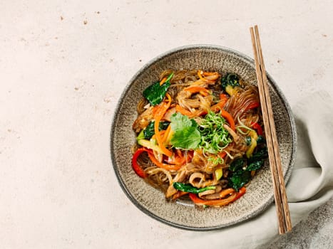 Asian noodles with meat and vegetables. Stir fry noodles with vegetables and beef, pork or chicken. Plate of asian buckwheat soba noodles with vegetables and chicken.