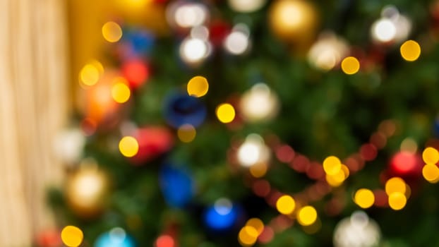 Colorful blurred christmas tree background with lights, strings and decorations