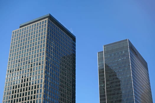 London, United Kingdom - February 03, 2019: 40 and 25 Bank Street buildings designed by Cesar Pelli & Associates on sunny day. Most of skyscrapers in London are in Canary Wharf area.