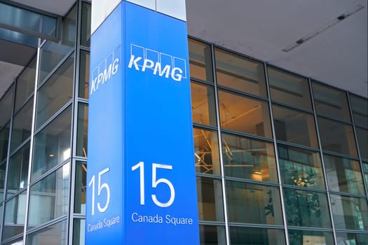 London, United Kingdom - February 03, 2019: Blue KPMG signage at entrance to their offices on 15 Canada Square in Canary Wharf - headquarters of company in the UK. It's one of big 4 accounting firms