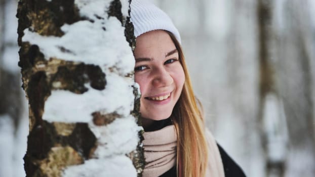 Portrait of a girl in winter in a birch forest