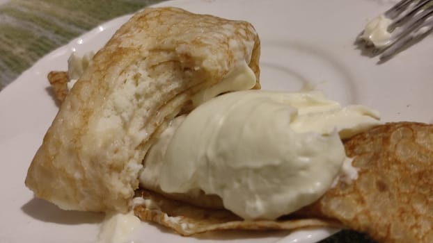 pancakes with cottage cheese and sour cream on a white plate, breakfast food. High quality photo