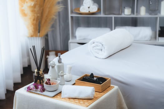 Exquisite display of beauty treatment and spa salon accessories arranged on spa table in luxury spa resort. Relaxing spa massage and recreation background concept. Quiescent