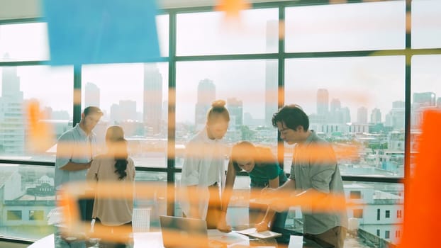 Group of diverse business people brainstorming about marketing plan. Multicultural business team working, talking, presenting about financial strategy with idea written on glass wall. Tracery