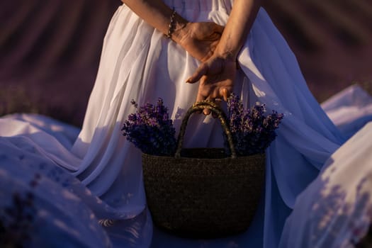 Back view woman lavender sunset. Happy woman in white dress holds lavender bouquet. Aromatherapy concept, lavender oil, photo session in lavender.