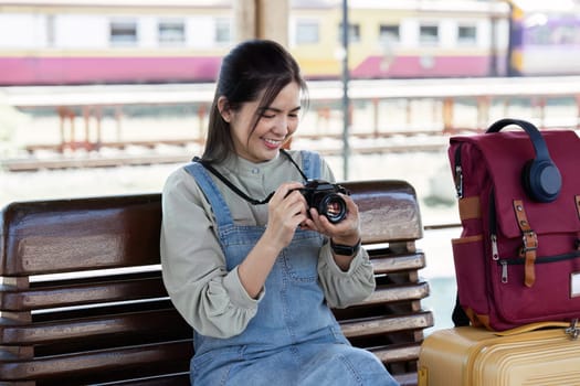 Young Asian woman backpack traveler using a camera. Journey trip lifestyle. travel concept.