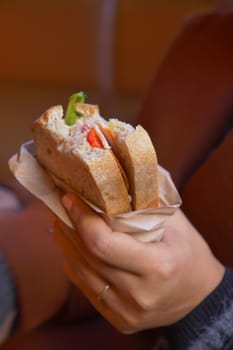 women hand pick Sandwich with ham, cheese, tomatoes,