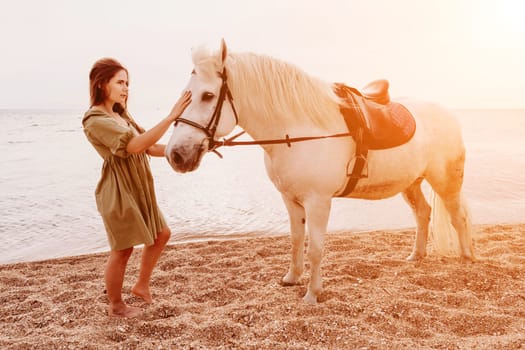 A white horse and a woman in a dress stand on a beach, with the sky and sea creating a picturesque backdrop for the scene