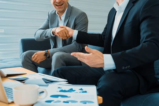 Businessman handshake with another businessman partner in modern workplace office. People corporate business deals concept. uds