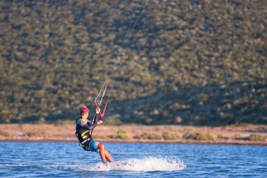 Gulbahce,Urla,Izmir,Turkey - July 30, 2023, People kite surf at the beach on a sunny afternoon in Gulbahce , Urla Izmir. High quality photo