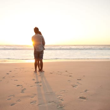 Man, woman and beach embrace at sunset or summer travel or adventure, bonding or marriage. Happy couple, love and sea hug for dating tourism or back view at nature vacation, environment or holiday.