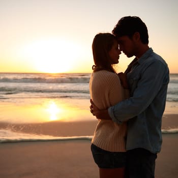 Couple, hug and love on beach at sunset for bonding marriage or vacation, weekend or peace. Man, woman and embrace on sea sand for calm on tropical holiday for coast adventure, summer or mockup space.