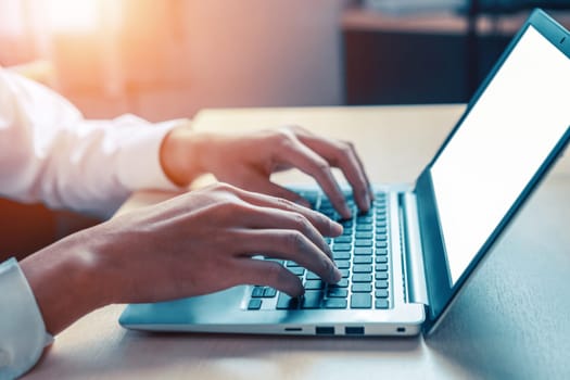 Businessman hand typing on computer keyboard of a laptop computer in office. Business and finance concept. uds