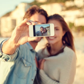 Couple, selfie and smile for hug by ocean for memory on vacation with care, love and tropical beach. Man, woman and smartphone screen for photography, profile picture and app by sea on social media.