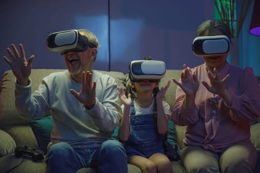 Asian elderly with child play VR video game, family entertainment, granddaughter and grandparents playing together exciting interesting video games using virtual reality headsets living room at home