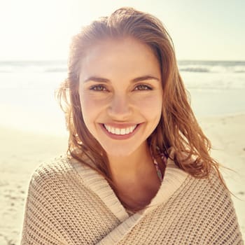 Portrait, travel and happy woman at a beach for summer, break or vacation, adventure or holiday. Ocean, face and female person smile at the sea with freedom, good mood or solo trip in South Africa.