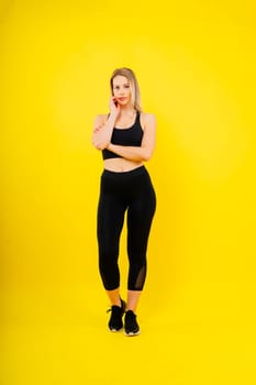 Happy fit woman on studio background. Smiling female fitness workout. Healthy lifestyle concept.