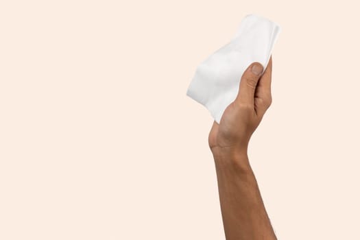 Black male hand holding a cleaning cloth isolated. Cleaning concept. High quality photo