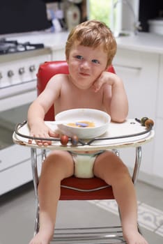 Eating, toddler and baby in chair for food, feeding or meal in house kitchen or home for breakfast. Hungry kid, wellness and healthy boy child with bowl for nutrition, natural diet or growth alone.