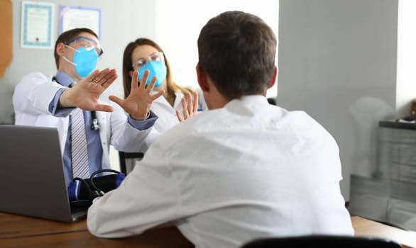 Patients look at scared doctors in respirators. Quarantine in clinic. Violation quarantine rules during clinic visit. Doctors refuse to listen to patients. Violate right to choose treatment