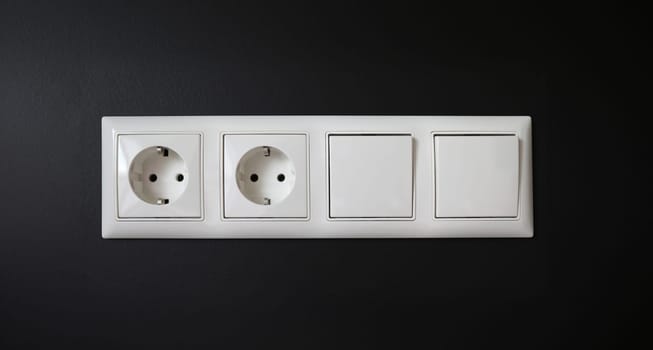 Integrated socket with switches installed in wall. Device is used to connect electrical appliances to network. Socket is grounded, which increases safety its use. Insulation damage