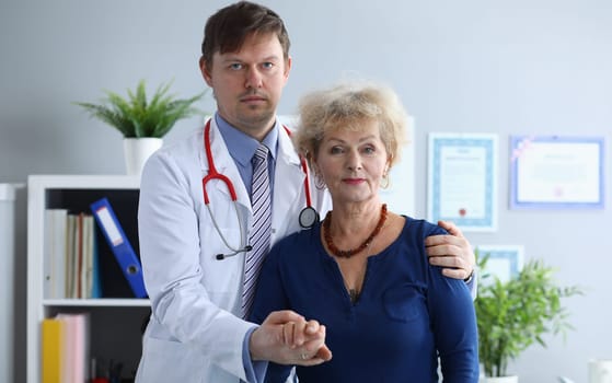 Doctor helps elderly woman to resist during illness. Social isolation elderly. Understanding mental state. Doctor reassuring patient after examination. Establish friendly communication with patient