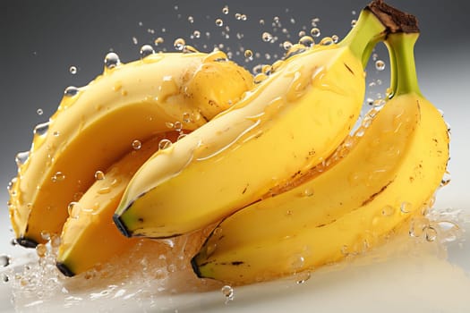 Ripe yellow bananas falling into water, splash of water from bananas, bananas in water with bubbles.