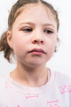 Little girl with rainbow braces smiling at the camera.