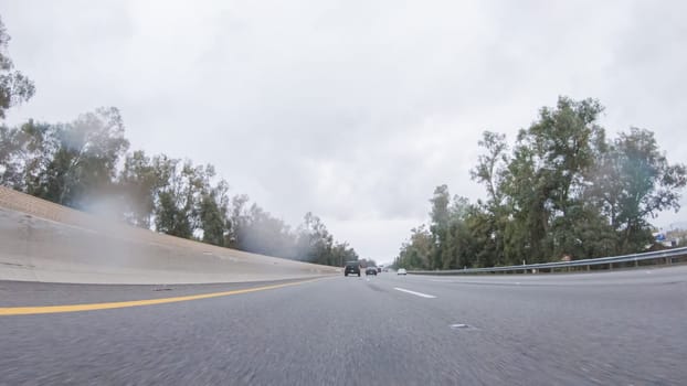 Amidst a rainy winter day, driving on HWY 134 near Los Angeles, California, captures the atmosphere through raindrop-covered lenses, adding a unique and moody perspective to the journey.
