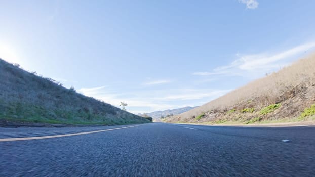 During the day, driving on HWY 101 near Arroyo Quemada Beach, California, offers scenic views of the surrounding coastal landscape.