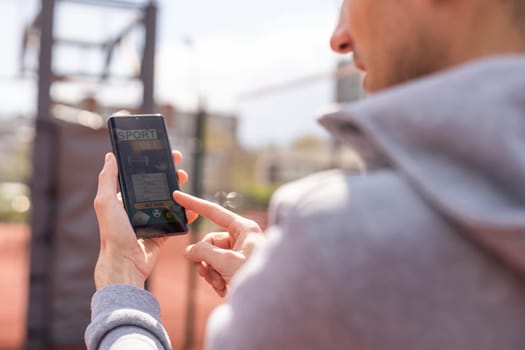 Man using online sports betting services on phone.