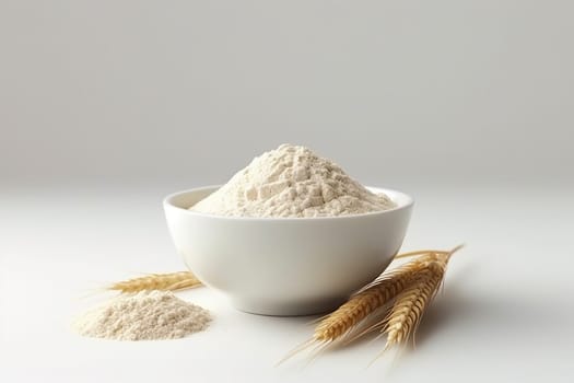 A bowl of flour with wheat spikes on a white background