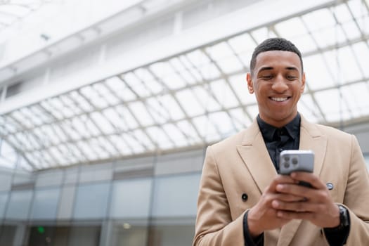 Businessman looking at the camera while standing alone in a modern workplace. High quality photo