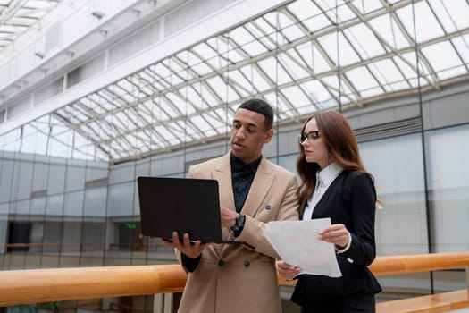 Happy young entrepreneurs smiling while working together in a modern workspace. High quality photo