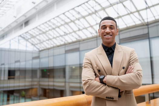 Businessman looking at the camera while standing alone in a modern workplace. High quality photo