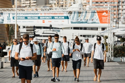 Monaco, Monte-Carlo, 18 October 2022: a group of yachtsmen participating in the upcoming sailing race goes to the yacht club, teams from different countries, the World Championship of J70 class. High quality photo