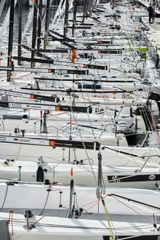 Monaco, Monte-Carlo, 18 October 2022: many sailing boats of the World Championship of J70 class participants stand in a row waiting for the wind for the stage of the sailing race. High quality photo