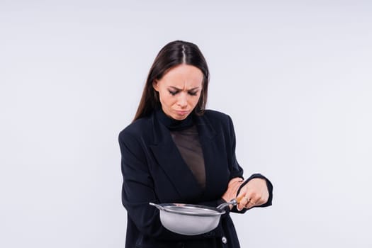 Female with metal sieve for sifting flour in a female hand on a red and white background.